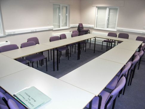 Room with tables set out for meeting
